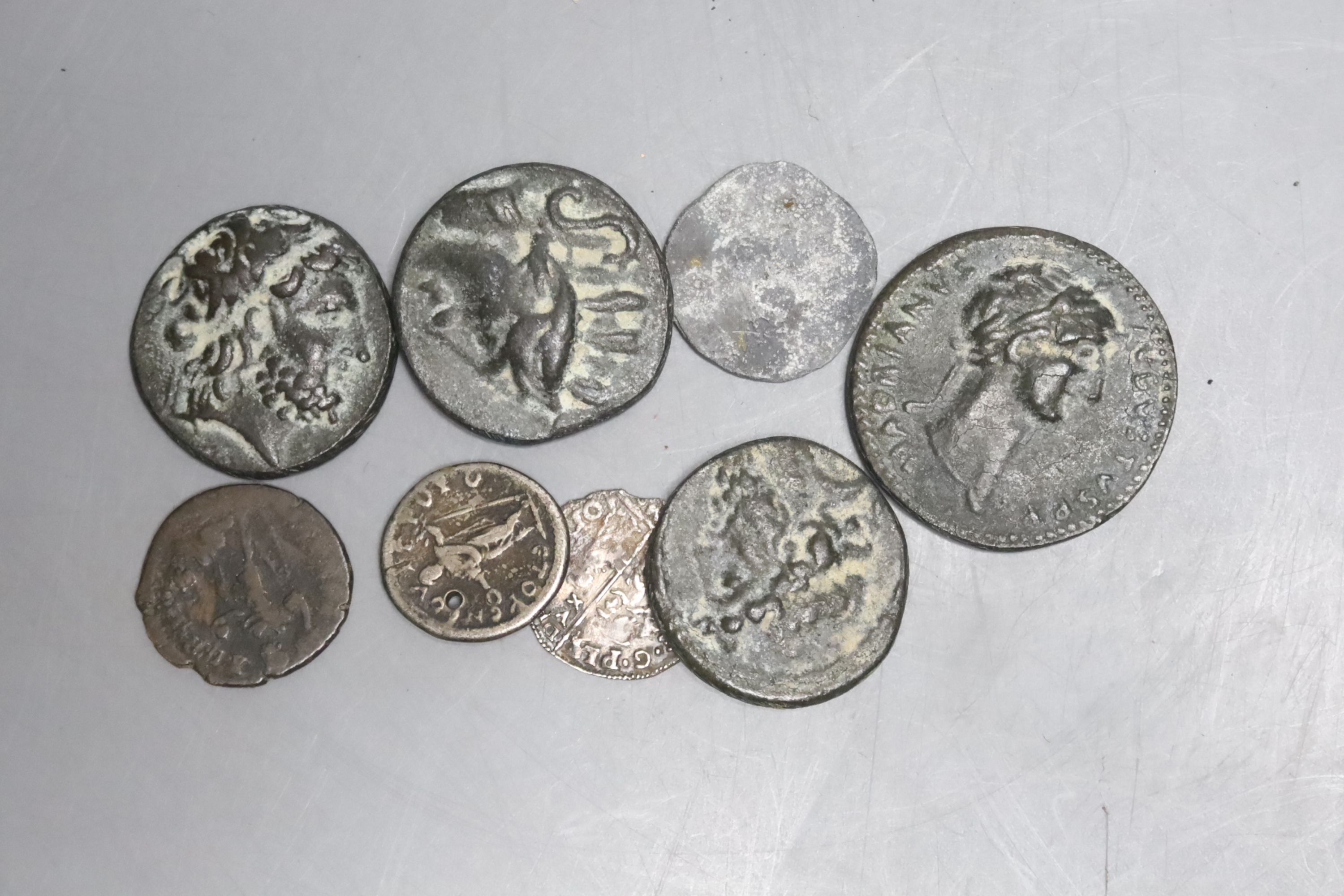 A Roman silver denarius, a hammered silver coin and various reproduction Roman coins.